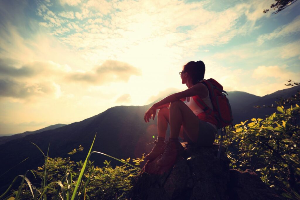 Woman enjoying sunset from top of a mountain | Counseling Services in Hurst